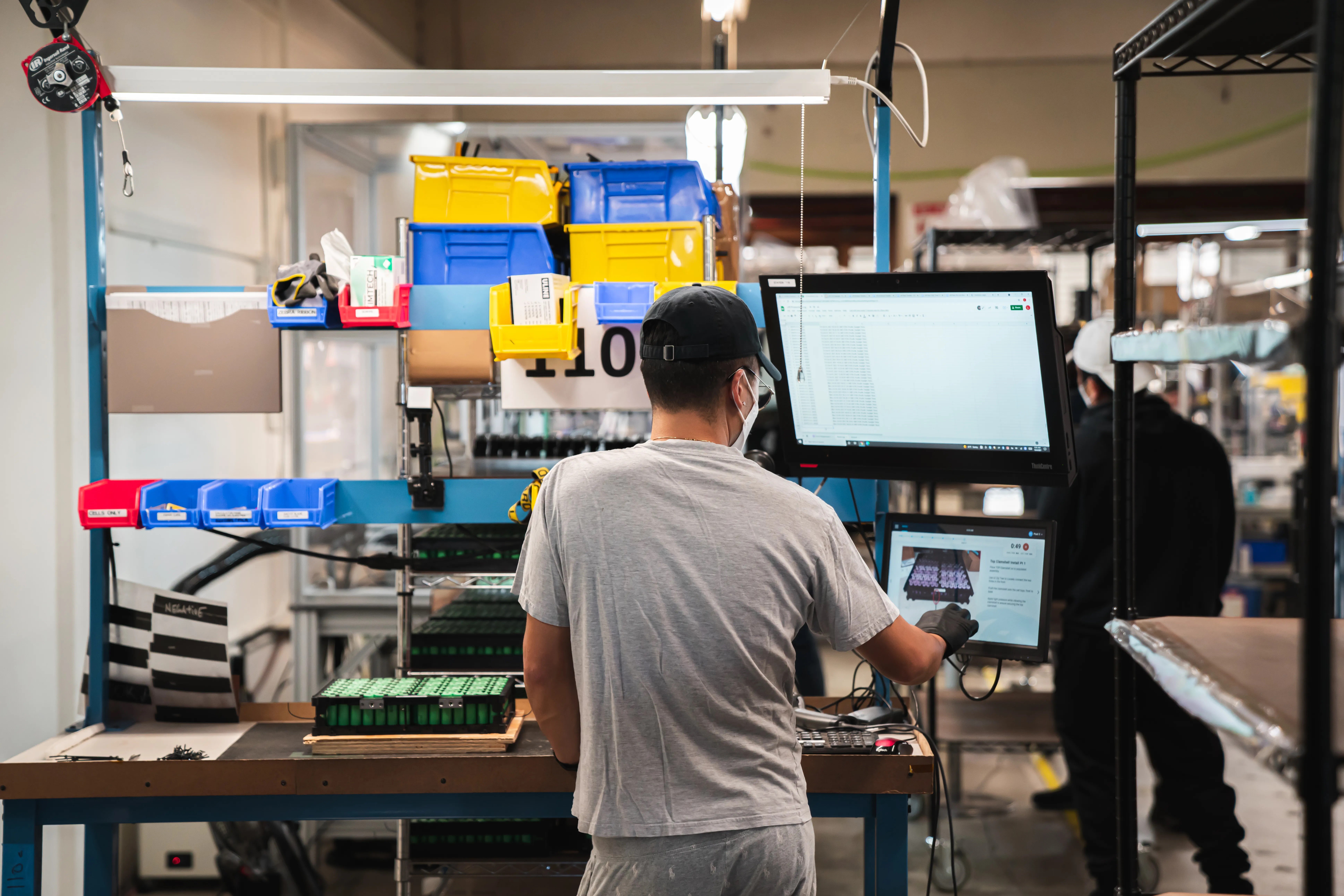 A worker at Lithos Energy uses PICO digital work instructions for battery production